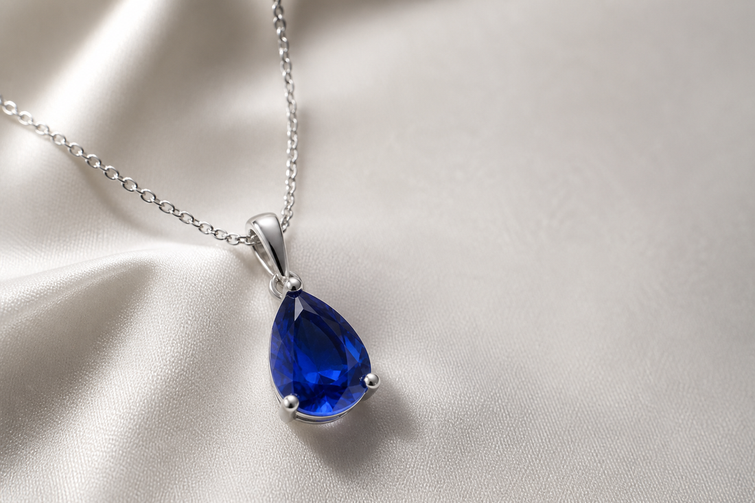 Lab-created blue sapphire pendant necklace on ivory silk