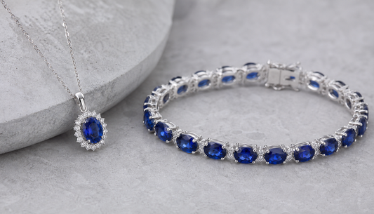 Lab-created sapphire jewelry on gray stone