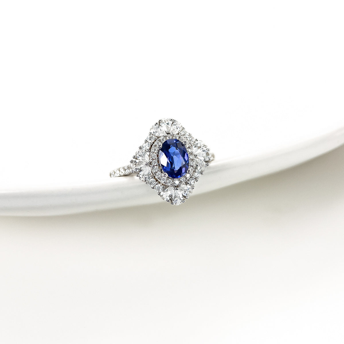 Lab-grown blue sapphire halo ring side view