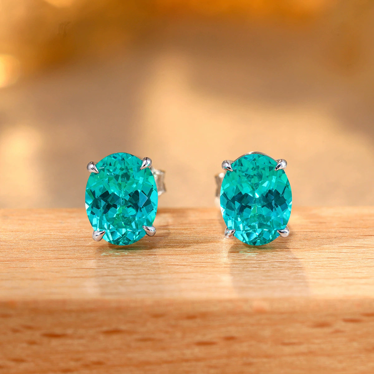Pair of oval Paraiba-color solitaire stud earrings