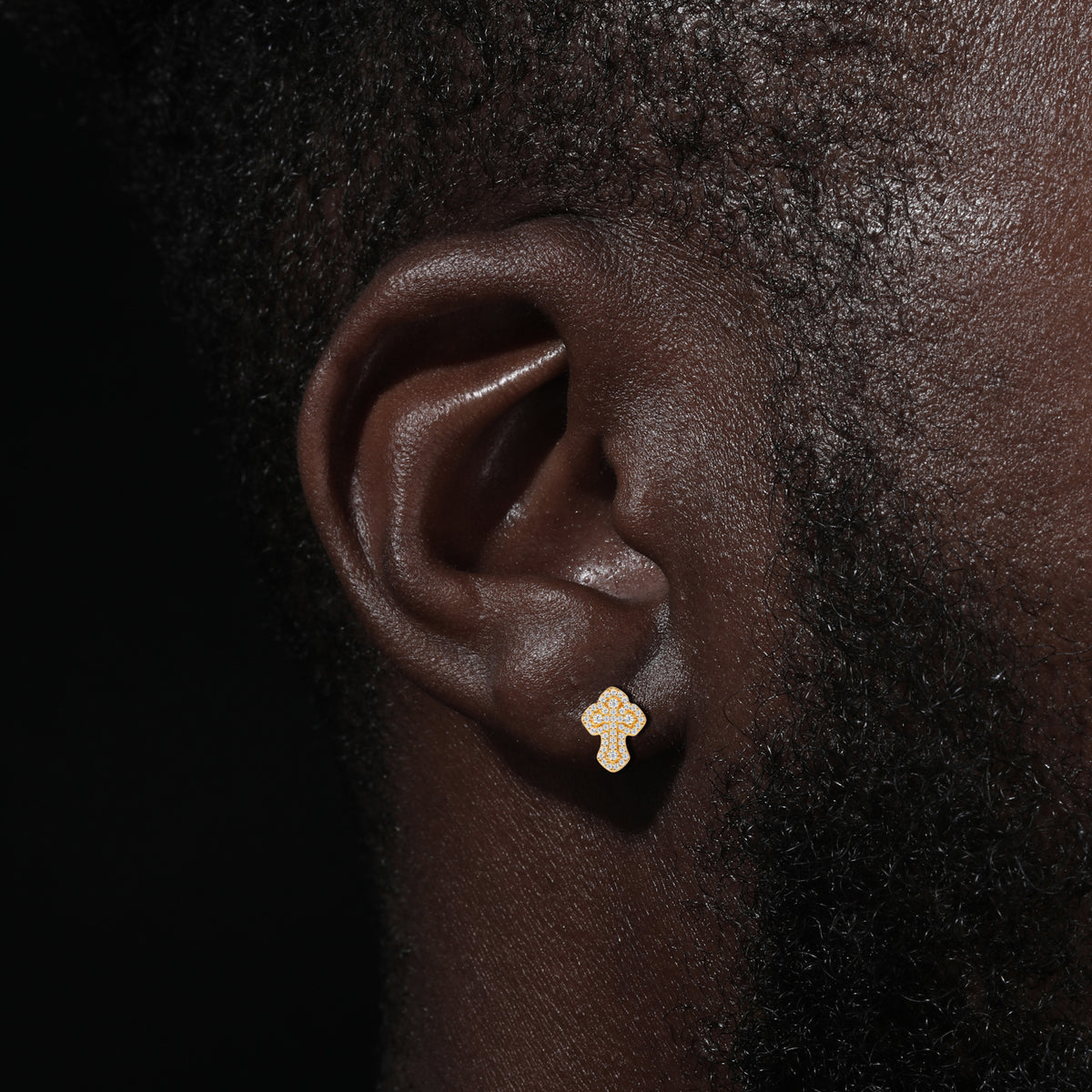 Layered cross moissanite stud earrings worn