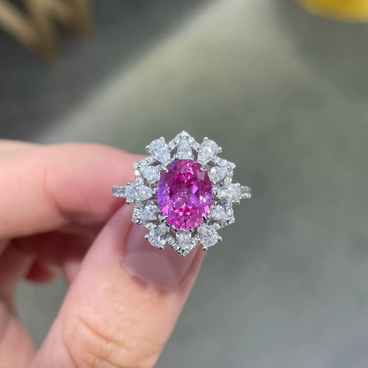 Oval pink sapphire ring with pear-shaped halo accents - view 3
