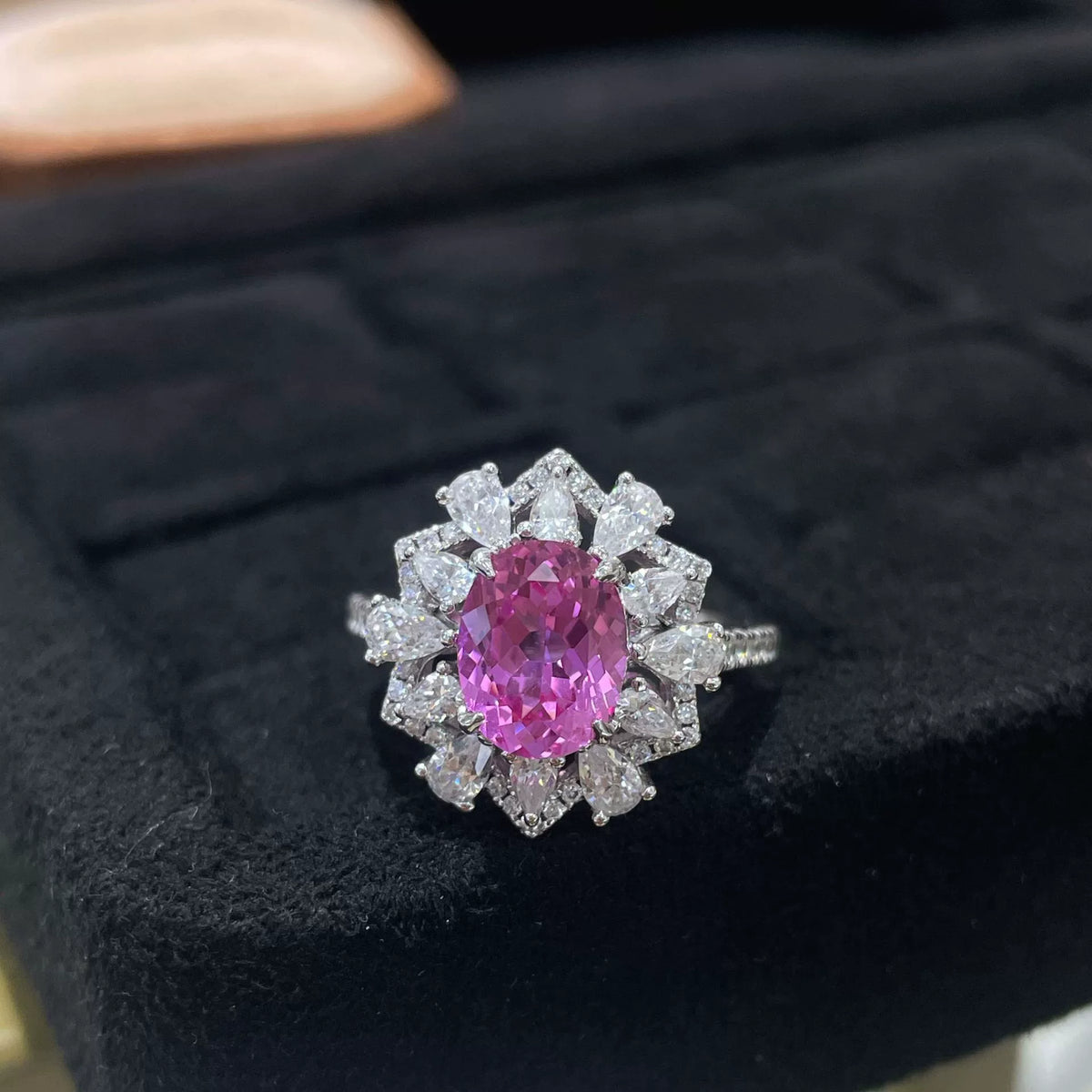 Oval pink sapphire ring with pear-shaped halo accents - view 1