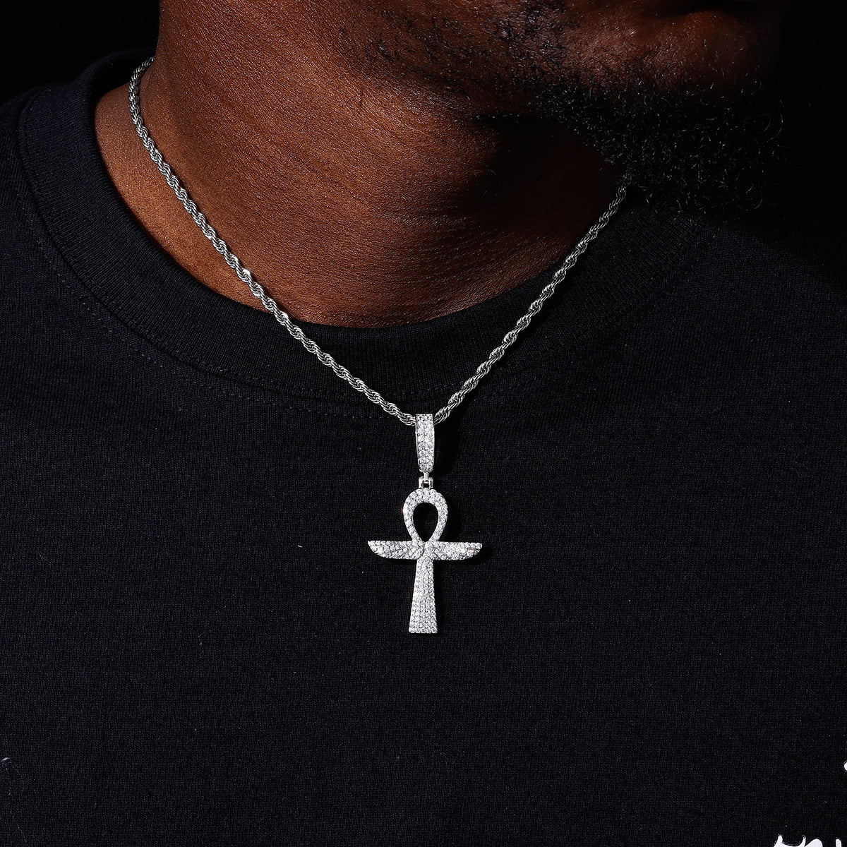 Silver-tone Ankh cross moissanite pendant shown for scale
