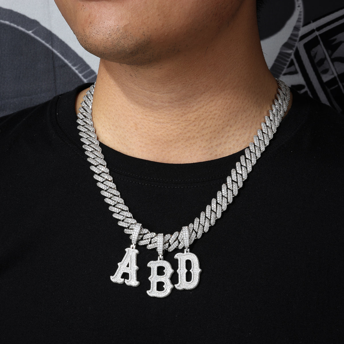 Bubble letter moissanite initial pendants styled on a Cuban chain