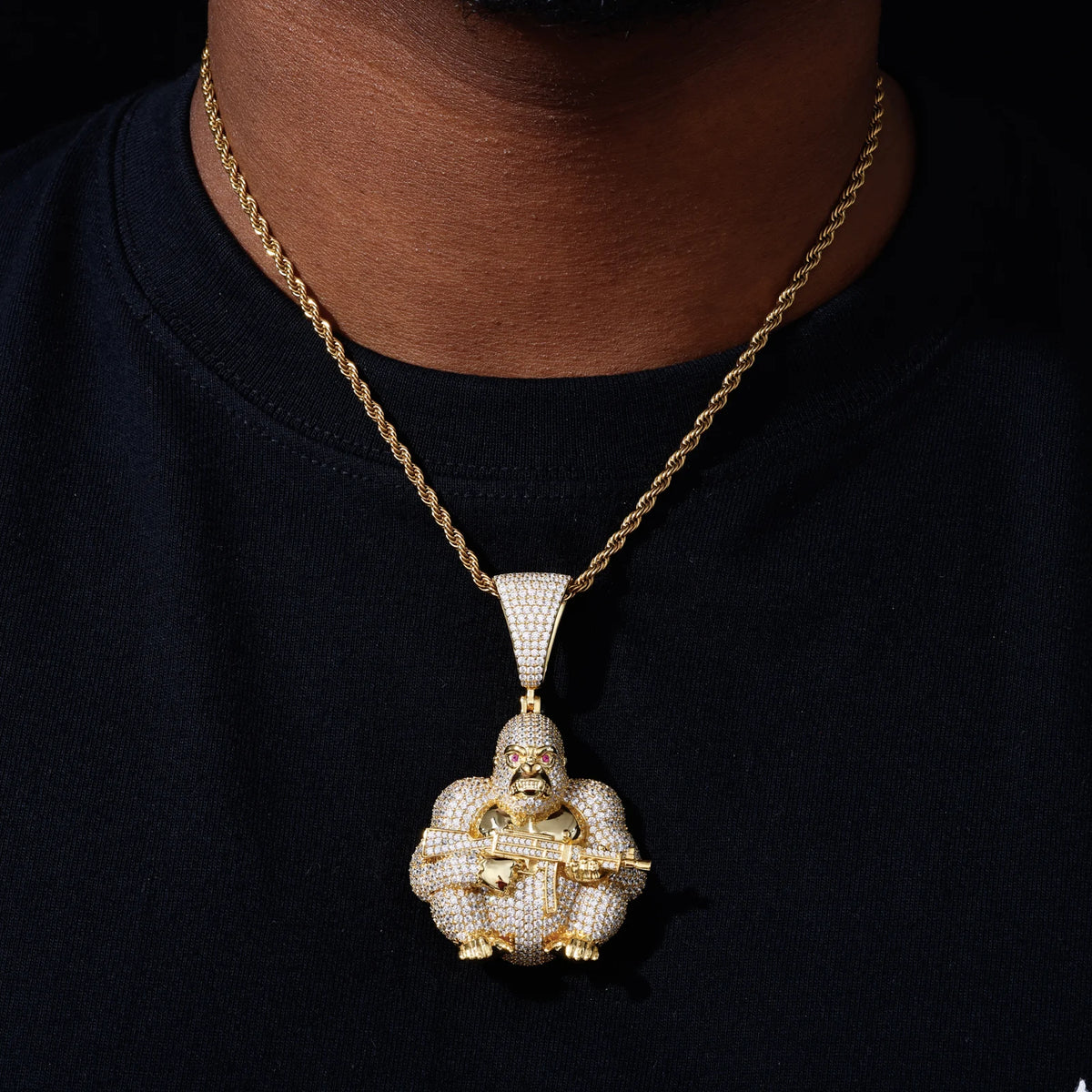Gold tone gorilla moissanite pendant worn with a rope chain
