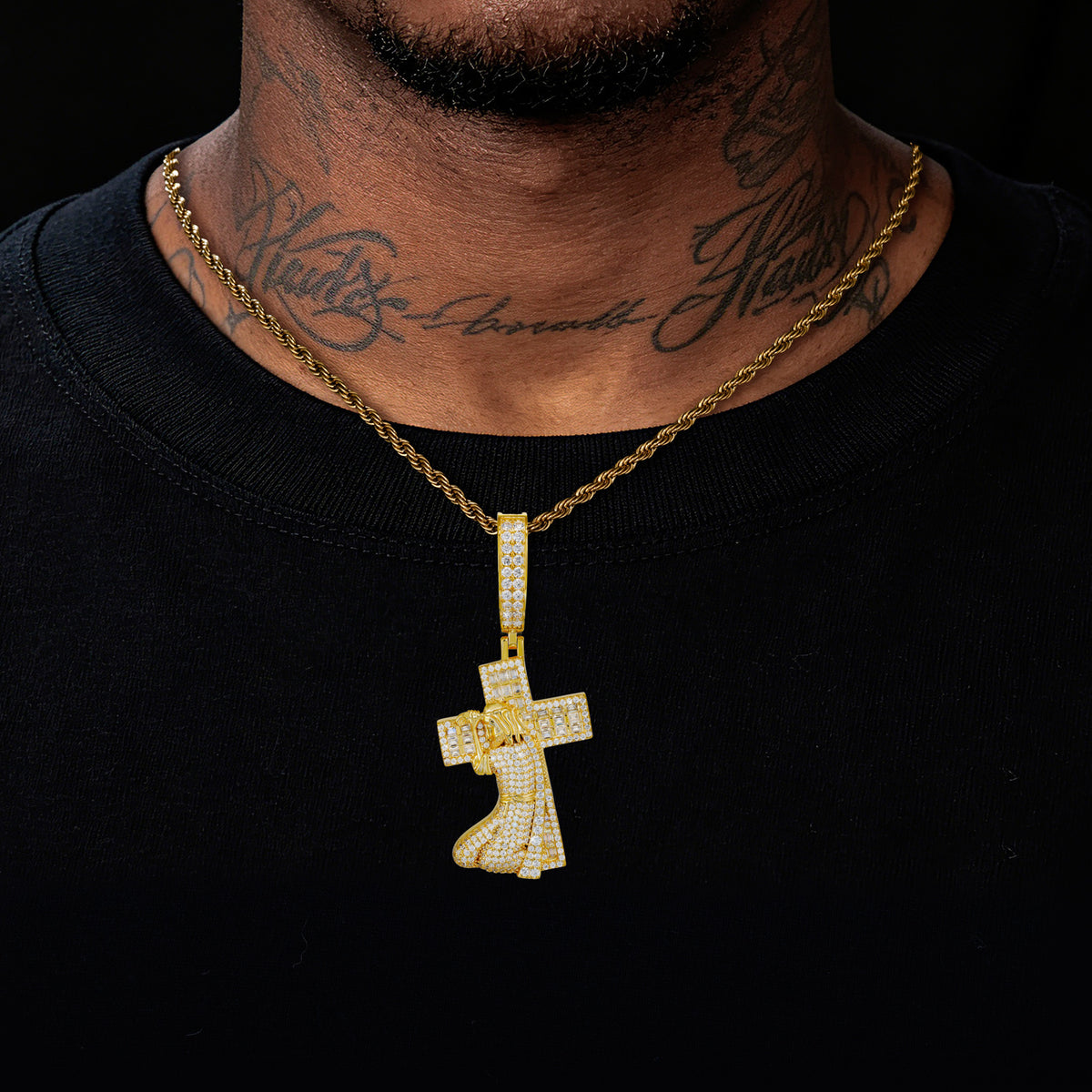Gold tone Jesus carrying cross moissanite pendant worn
