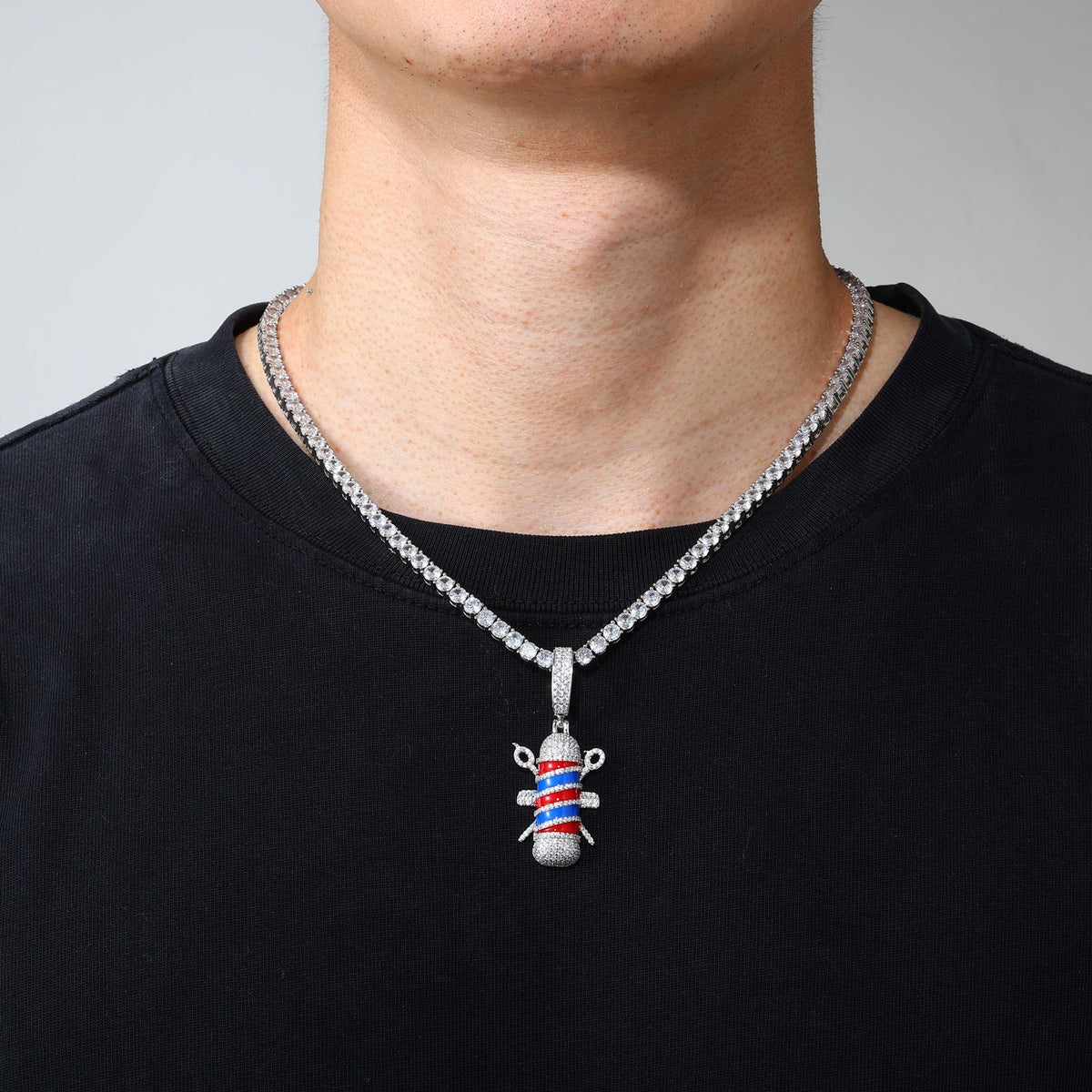 Gold-tone barber pole pendant worn