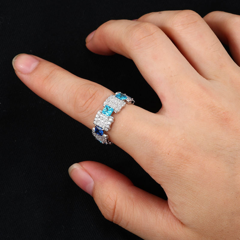 Blue CZ geometric ring on hand