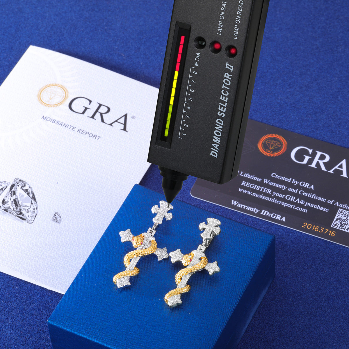 Snake cross pendant shown with moissanite report and tester