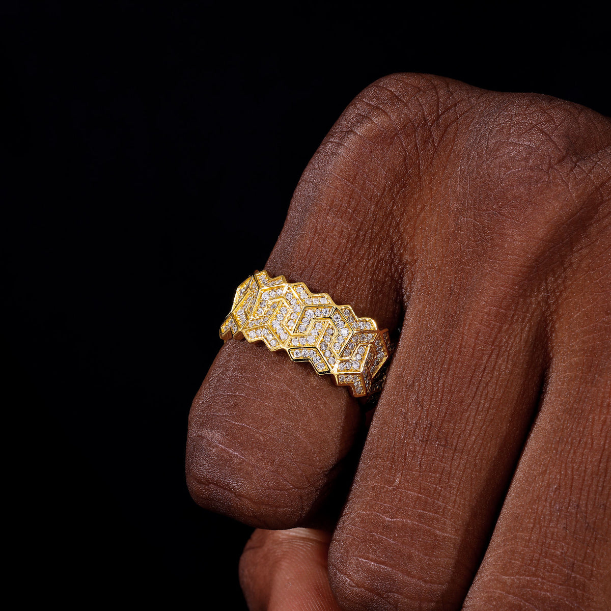 Gold-tone geometric moissanite ring on hand
