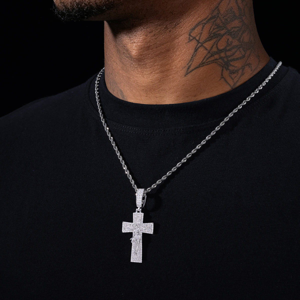 Silver-tone moissanite crucifix cross pendant worn on rope chain