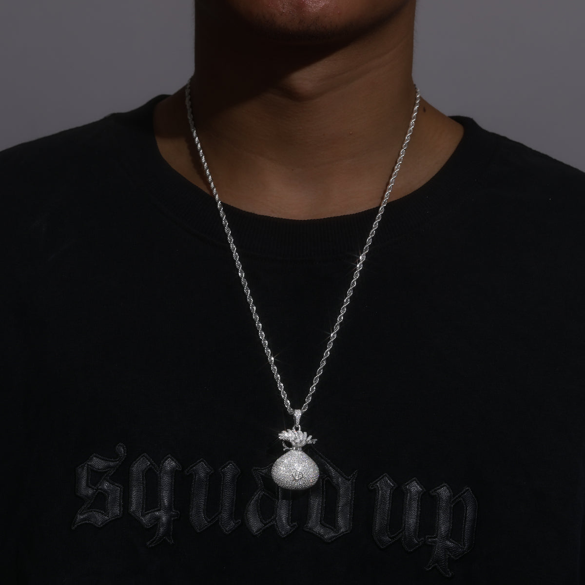 Moissanite money bag pendant worn on a rope chain