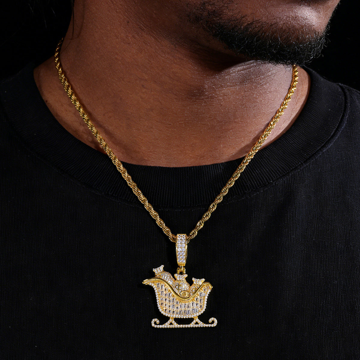 Gold-tone money bag sleigh moissanite pendant worn