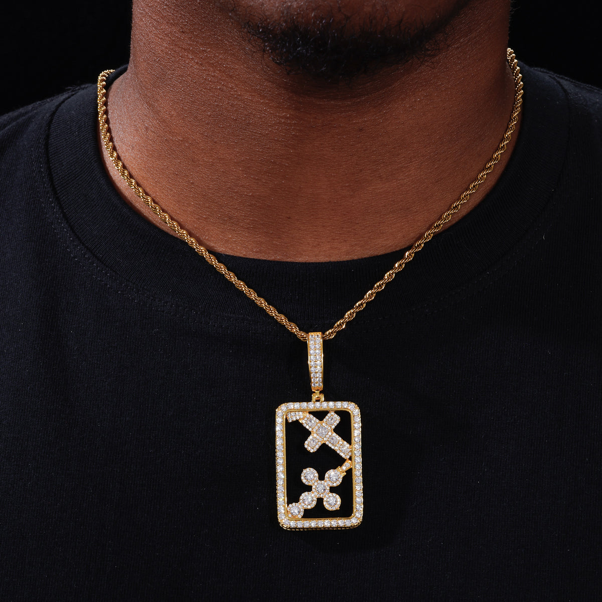 Gold tone openwork cross dog tag pendant worn