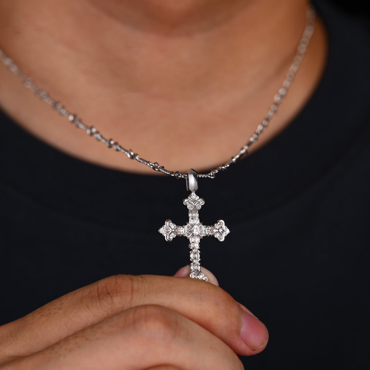 Silver-tone ornate iris cross moissanite pendant worn