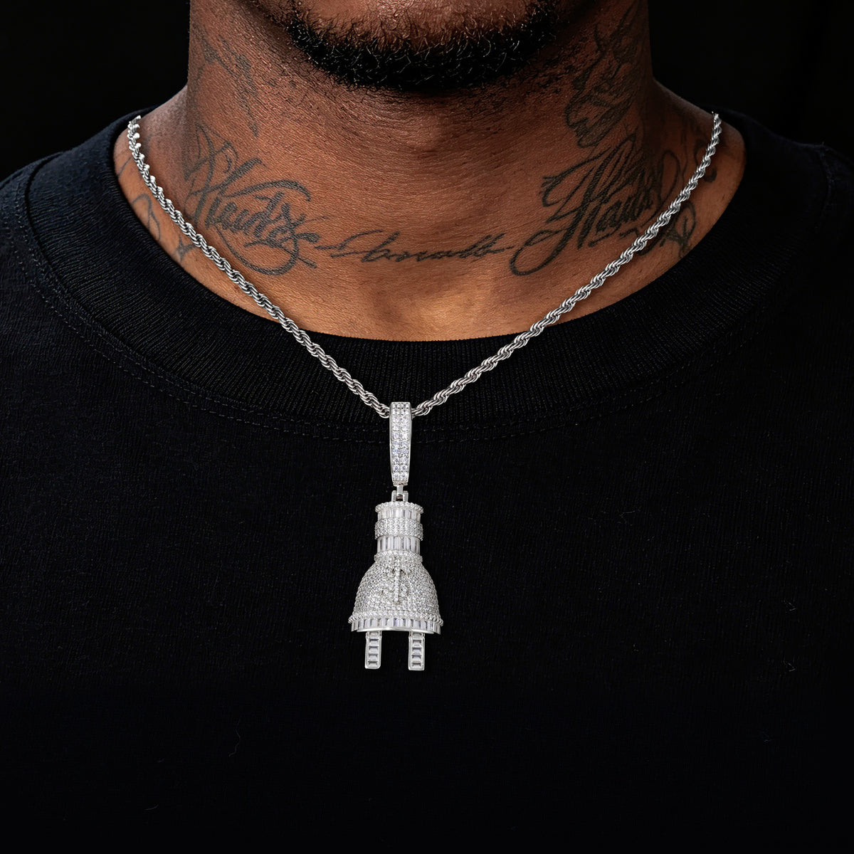 Silver-tone plug and dollar sign moissanite pendant worn