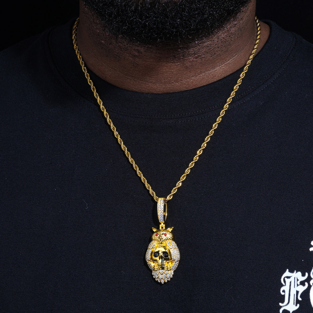 Gold-tone skeleton owl moissanite pendant worn on a chain
