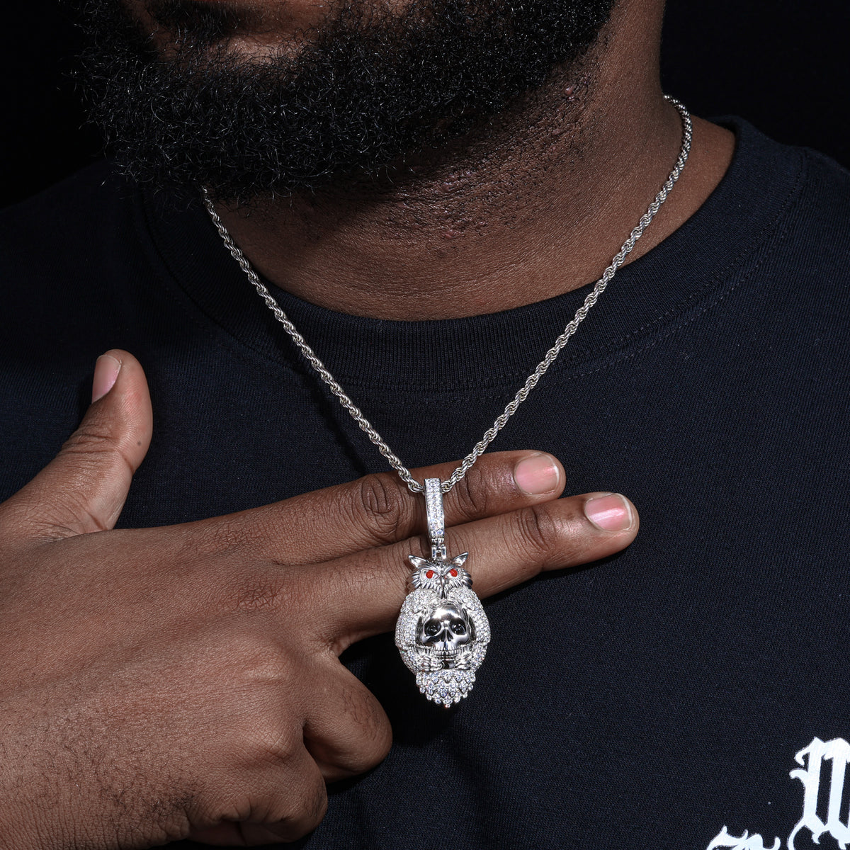 Silver-tone skeleton owl moissanite pendant worn on a chain