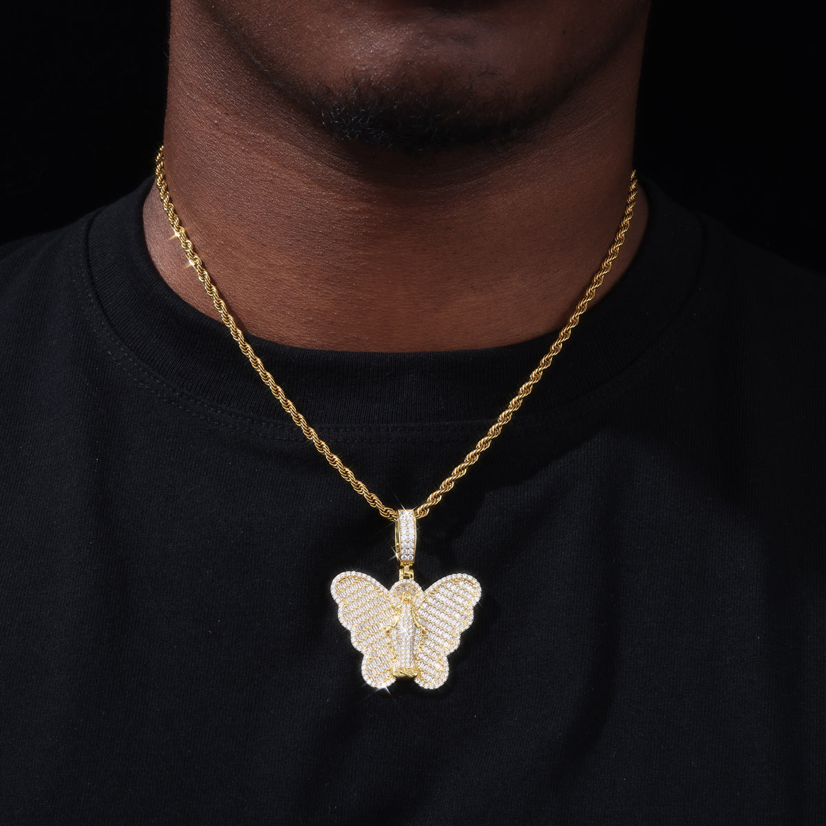 Gold-tone Virgin Mary butterfly moissanite pendant worn