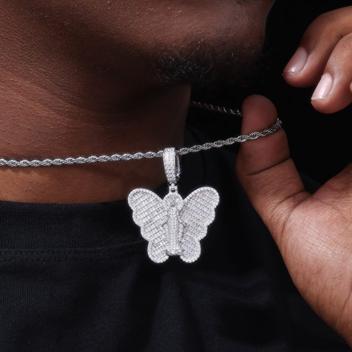 Silver-tone Virgin Mary butterfly moissanite pendant worn