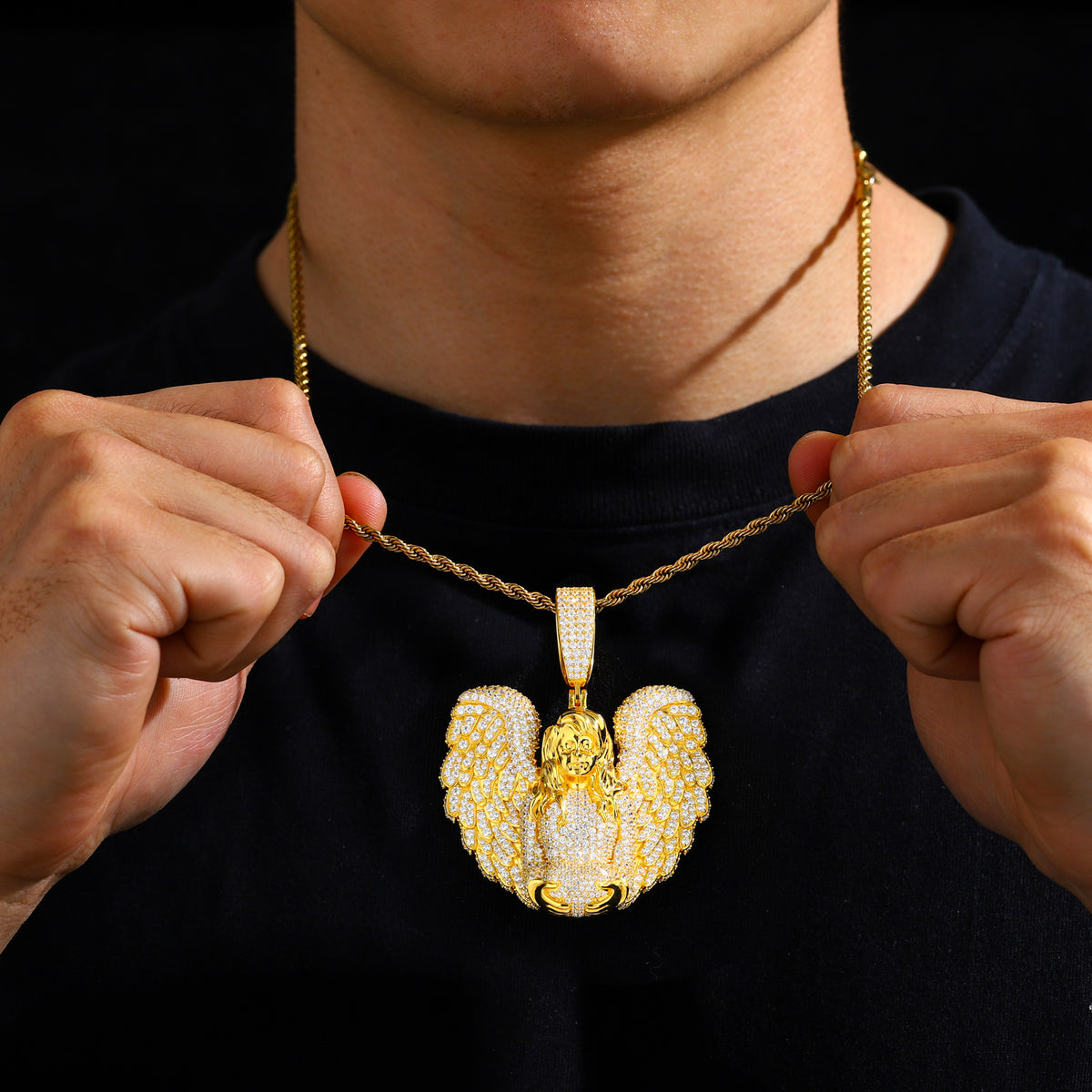 Gold-tone winged angel moissanite pendant worn on a chain