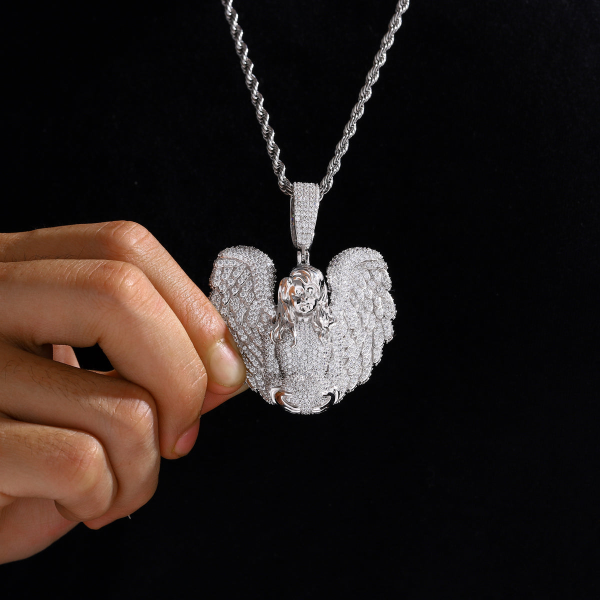 Silver-tone winged angel moissanite pendant worn on a chain