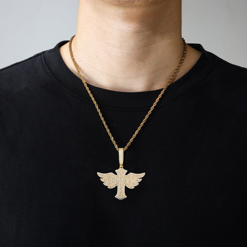Gold tone winged cross moissanite pendant worn